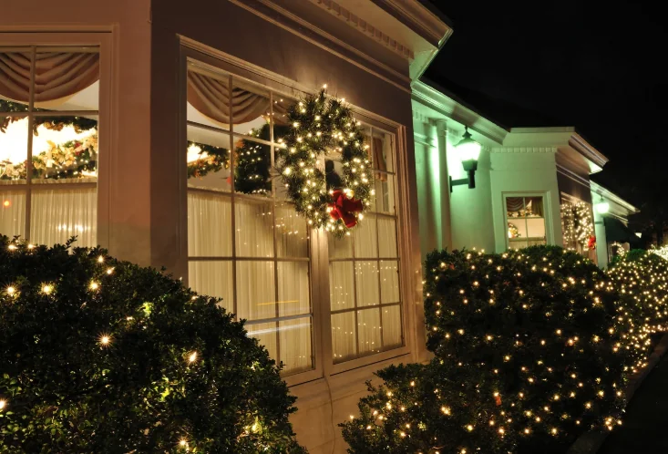 Home decorated with Christmas lights and wreaths — holiday lighting services in Charlottesville, VA