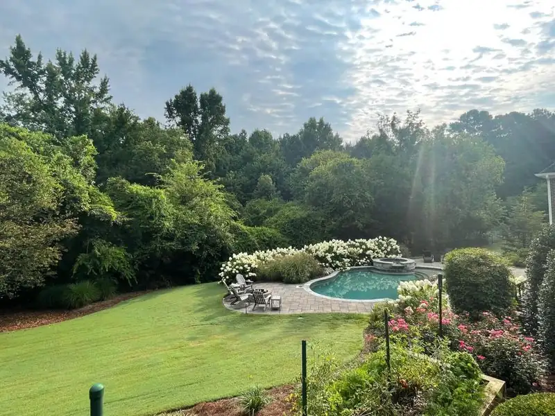 Thick striped lawn with pool area