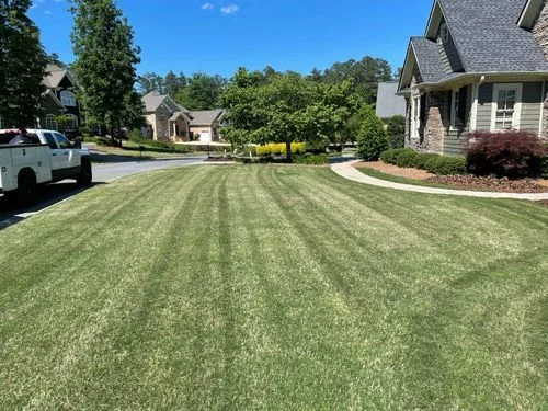 Crew truck and freshly mowed striped front yard